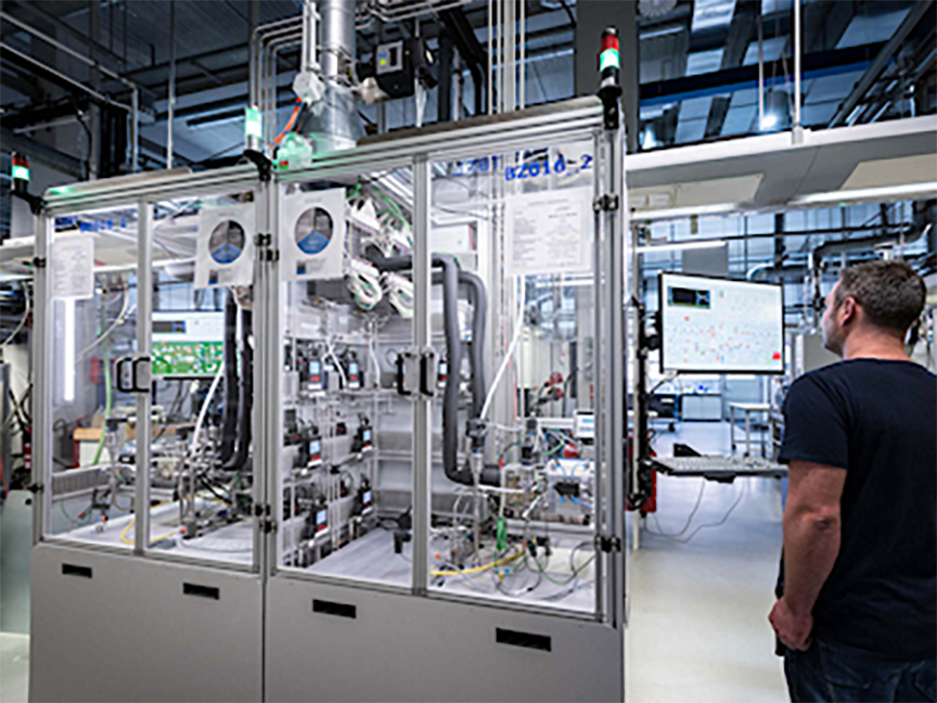 An engineer monitoring a gas mixing setup inside a fuel cell test chamber